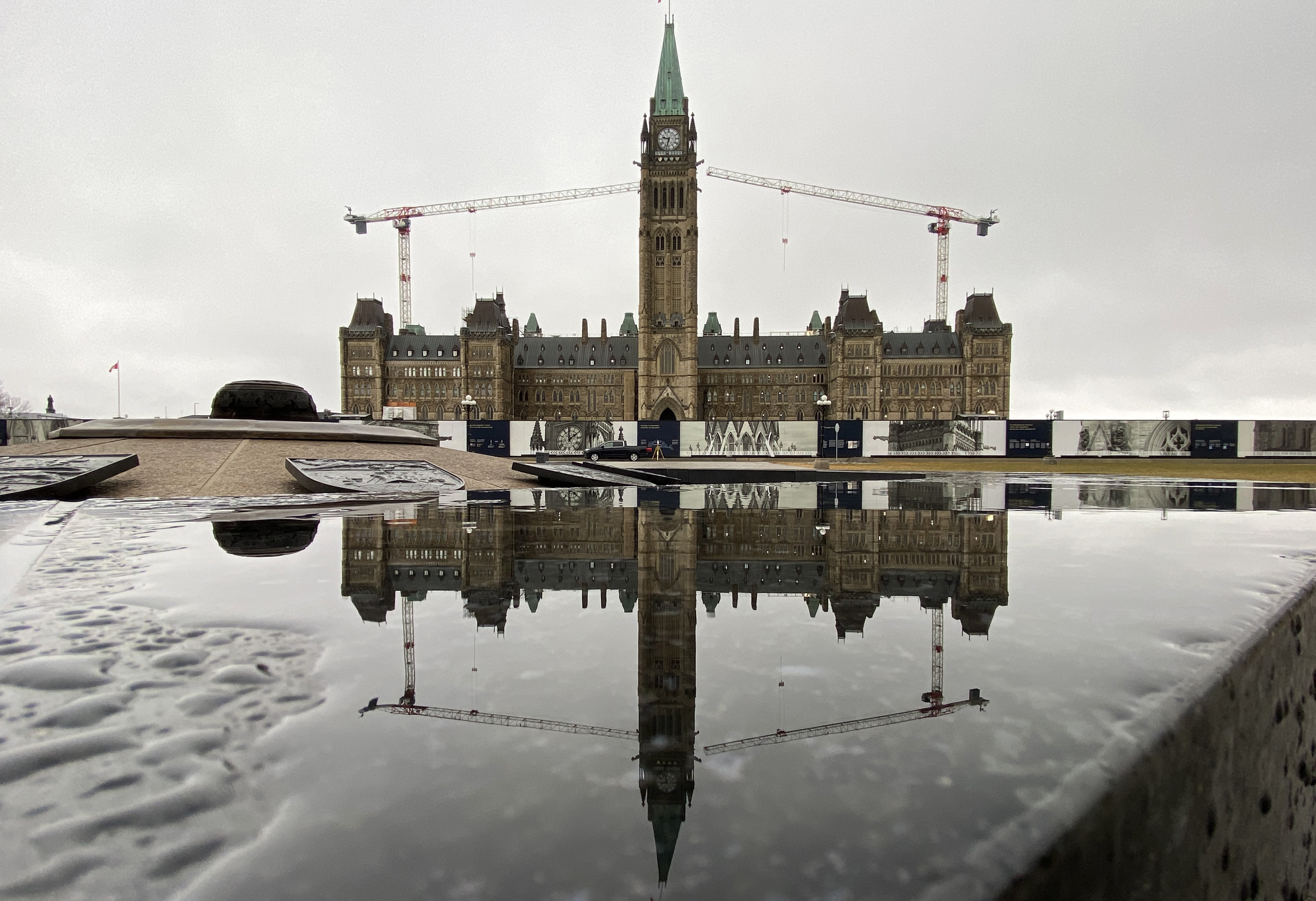 L'édifice du Centre de la Colline du Parlement se reflète dans l'eau, le jeudi 24 mars 2022 à Ottawa.