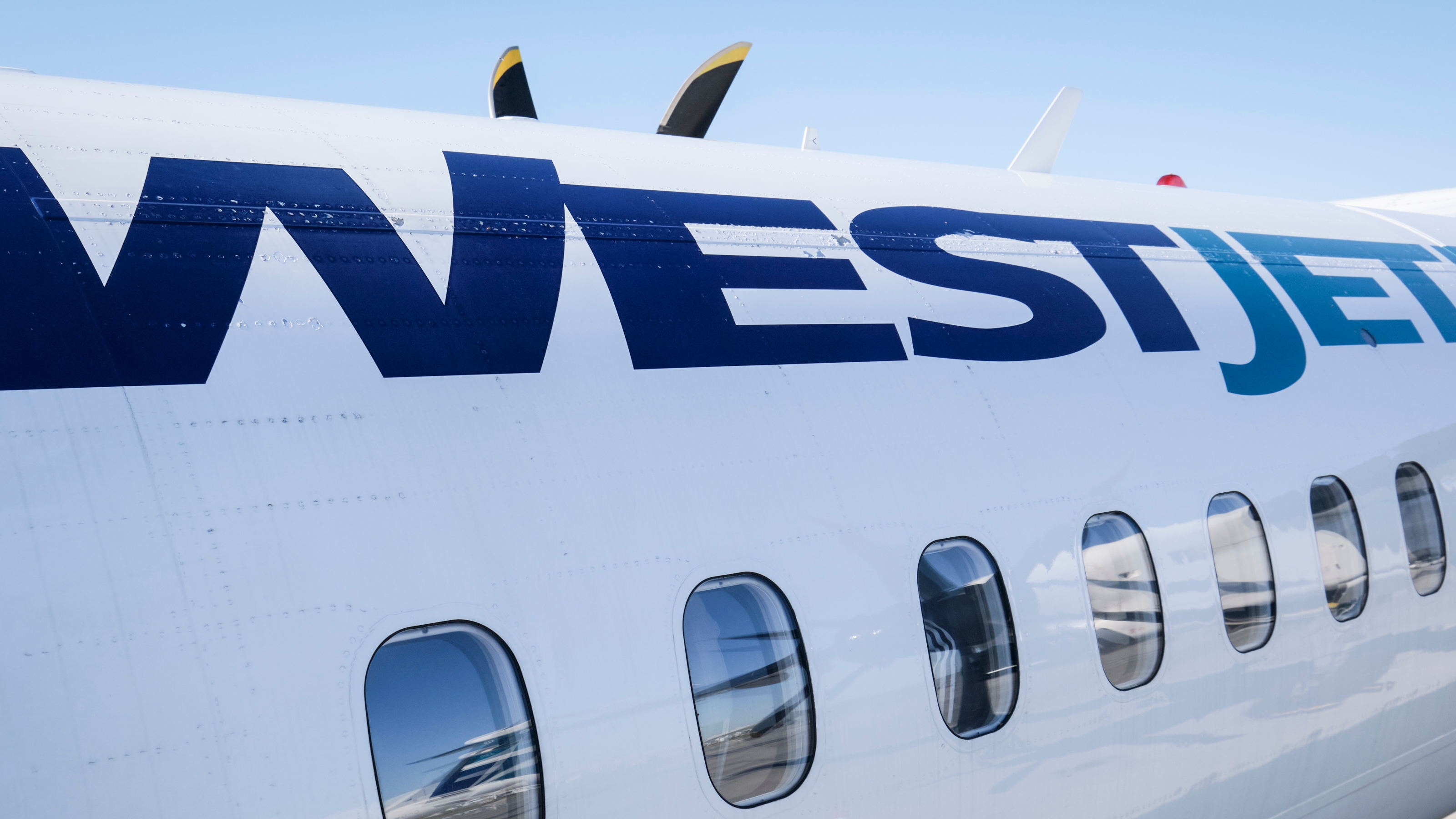 A WestJet plane waits at a gate at Calgary International Airport in Calgary, Alta., Wednesday, Aug. 31, 2022. WestJet says it is investigating after a customer's personal information was shared across the airline's social media accounts Thursday. THE CANADIAN PRESS/Jeff McIntosh