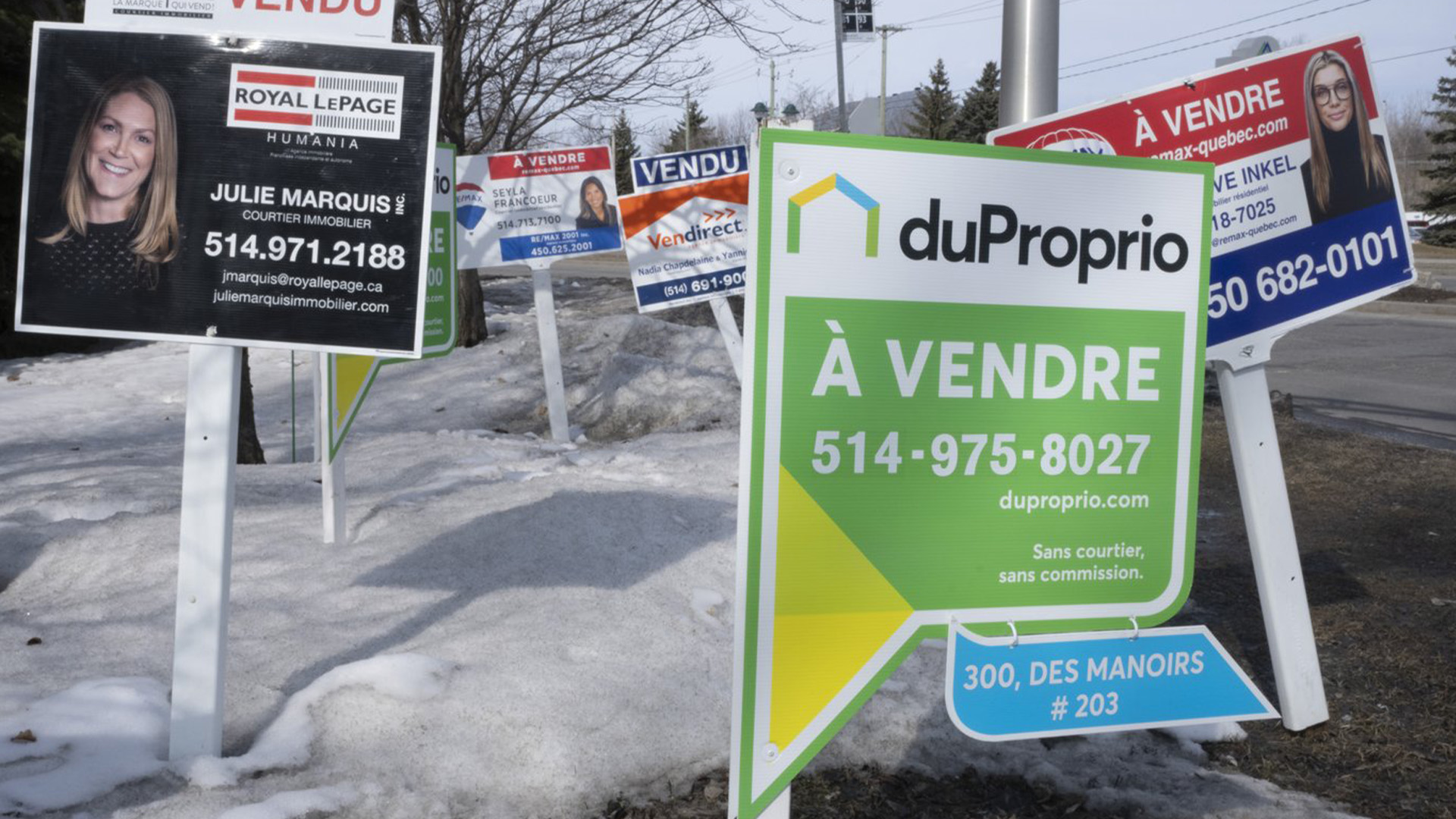 Des panneaux de condo à vendre sont visibles à Deux-Montagnes, au Québec, le mercredi 29 mars 2023.