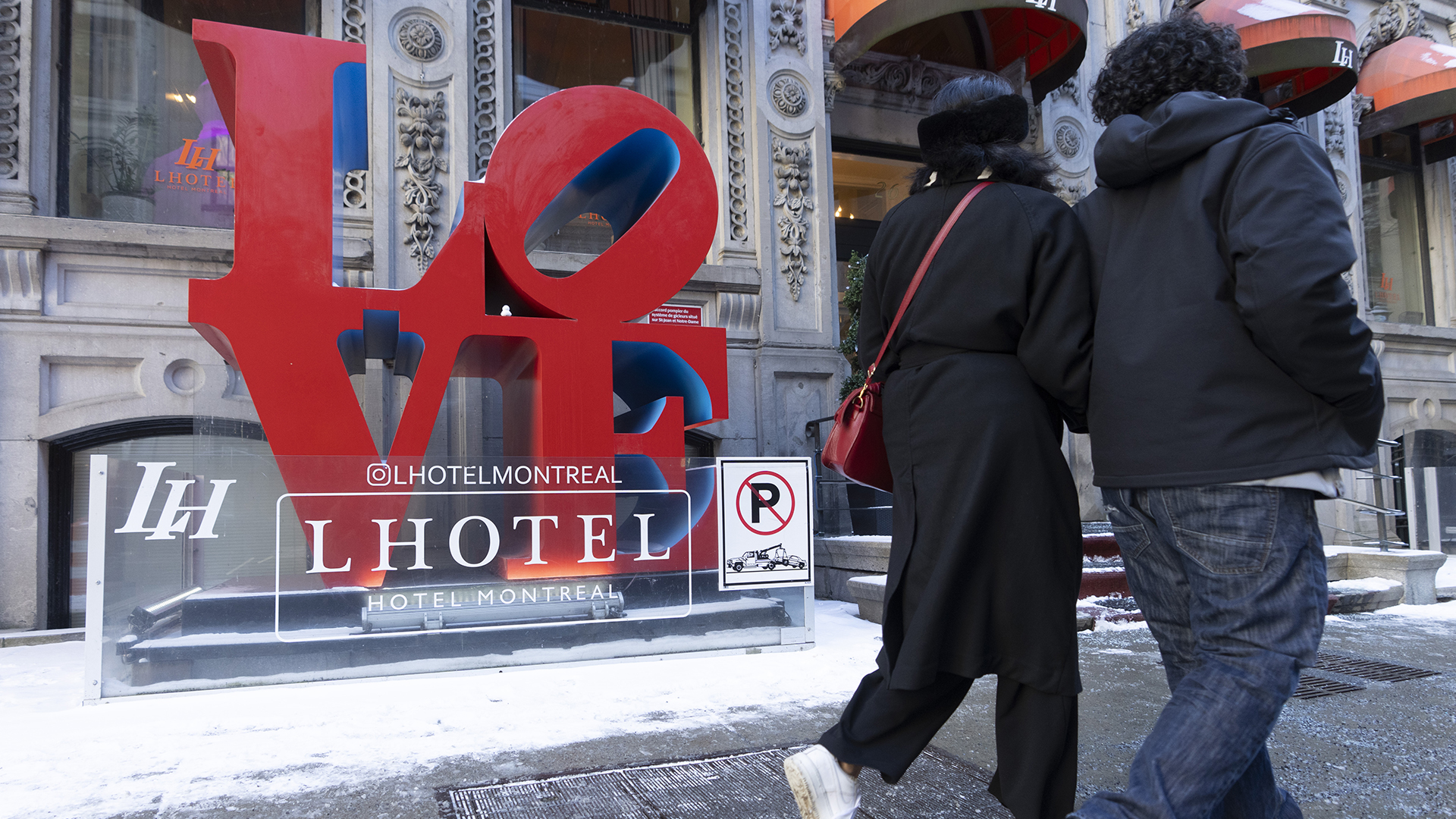 Des piétons passent devant le LHotel à Montréal le 14 février 2024.