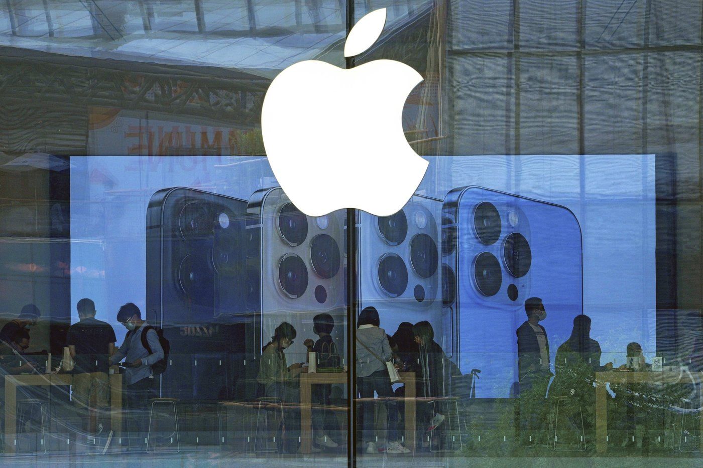 Des gens testent des produits iPhone dans un magasin Apple à Pékin le 28 septembre 2021.