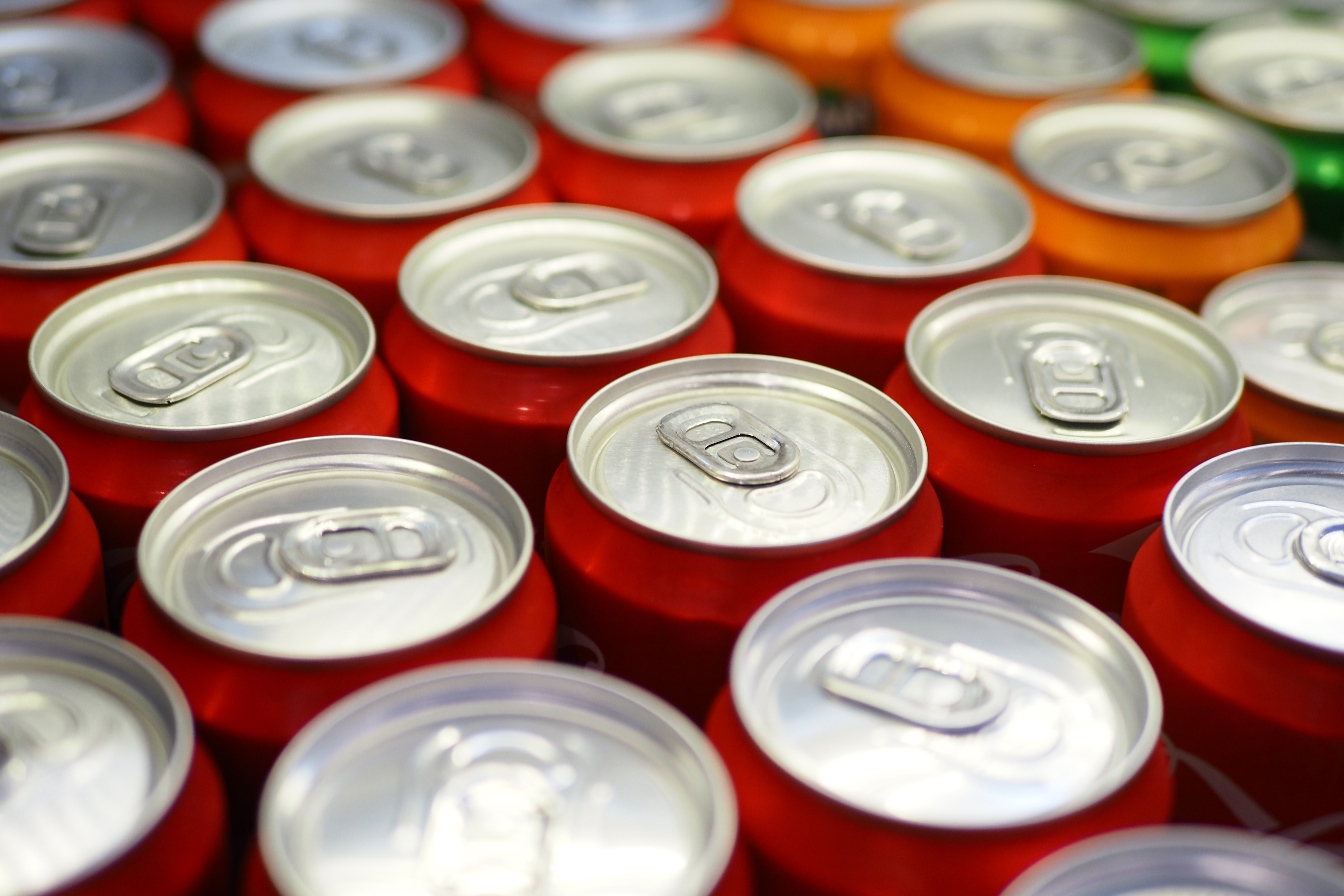 Cans of soft drink lined up 