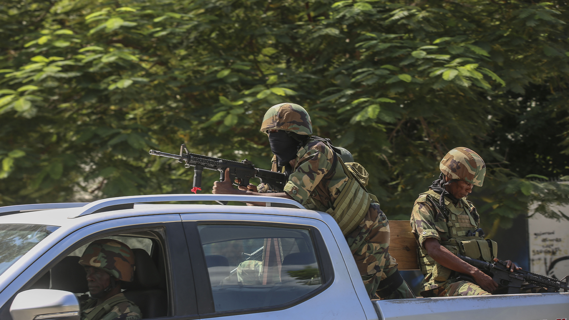 Soldiers patrol amid the sound of gunshots heard in the distance, in Port-au-Prince, Haiti, Thursday, Oct. 17, 2024.