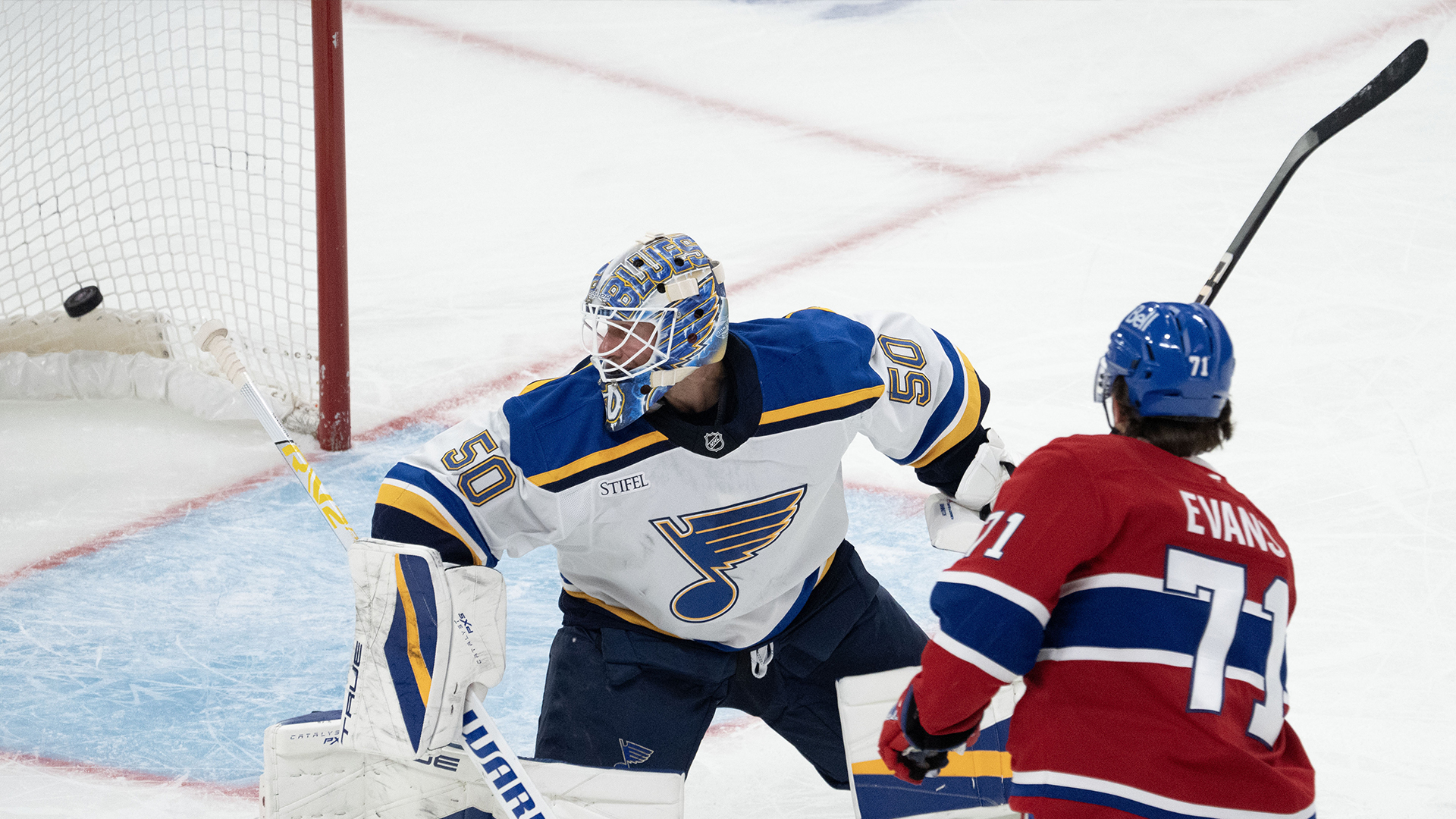 Jake Evans (71) des Canadiens de Montréal marque sur le gardien des Blues de St-Louis Jordan Binnington (50) lors de la première période de la LNH, le samedi 26 octobre 2024 à Montréal.