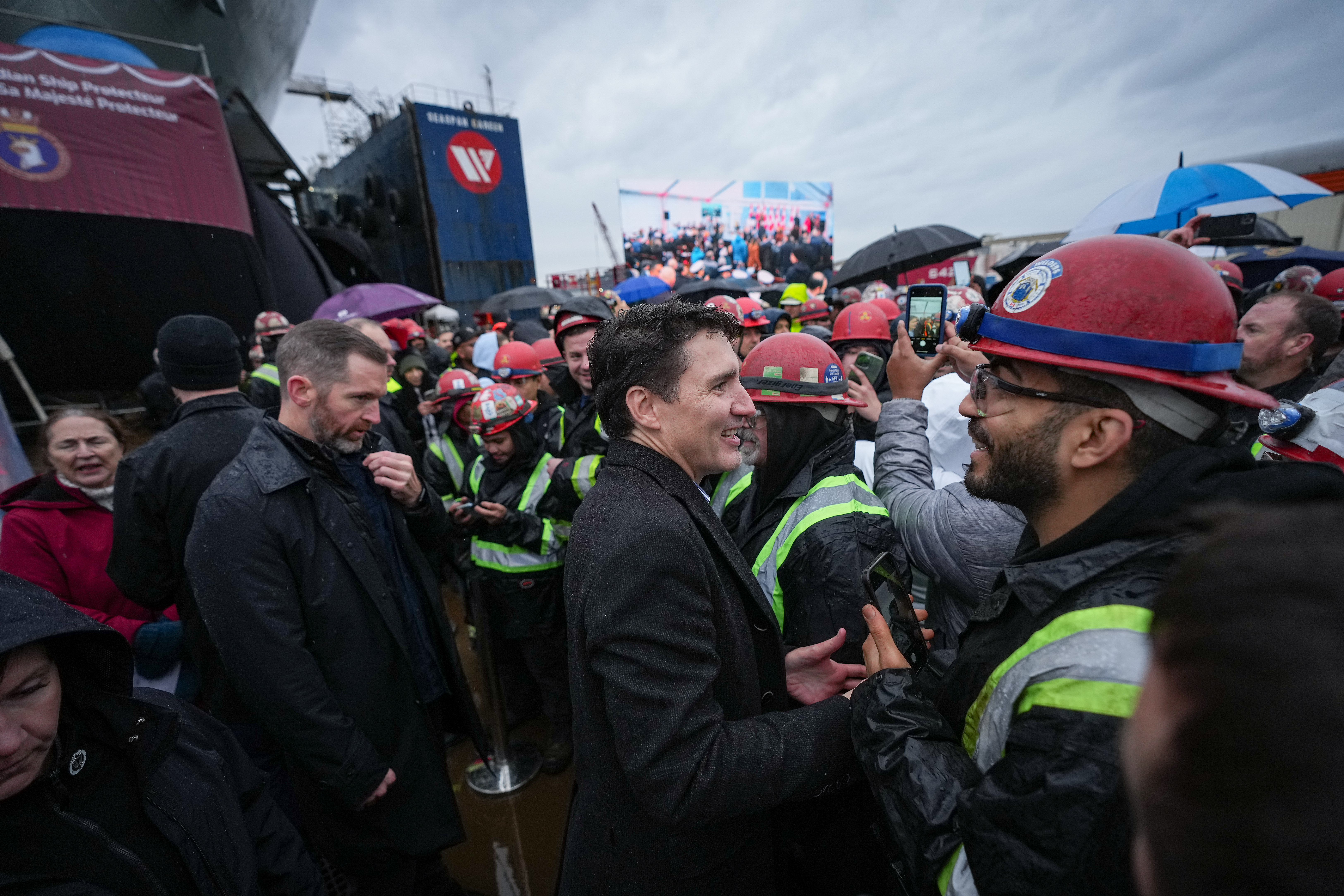 Prime Minister Justin Trudeau greets workers after a launch and naming ceremony for the new Royal Canadian Navy Joint Support vessel HMCS Protecteur, at Seaspan Shipyards in North Vancouver, B.C., on Friday, December 13, 2024. THE CANADIAN PRESS/Darryl Dyck