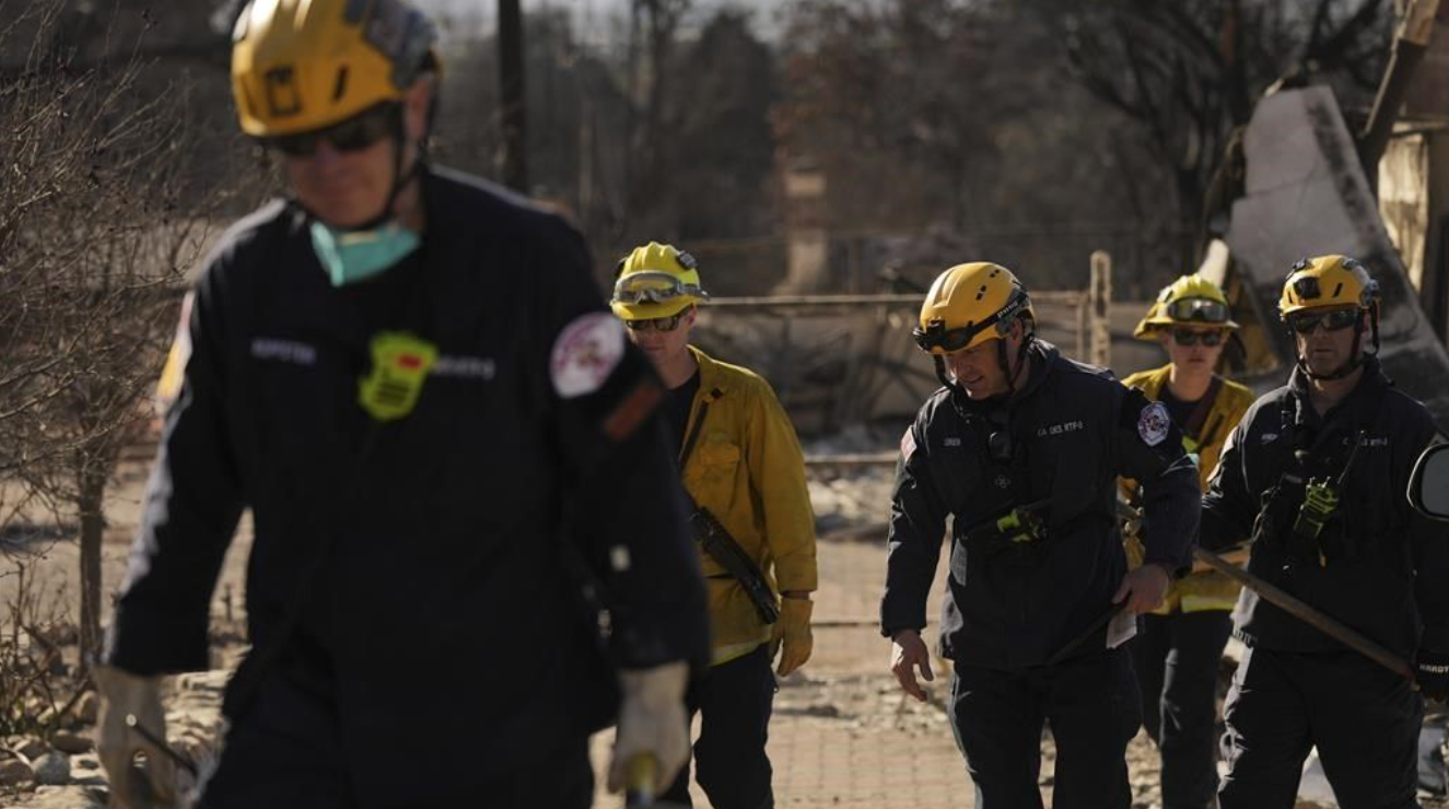 Des secouristes creusent dans les décombres laissés par l'incendie d'Eaton, à Altadena, en Californie, le mardi 14 janvier 2025. 