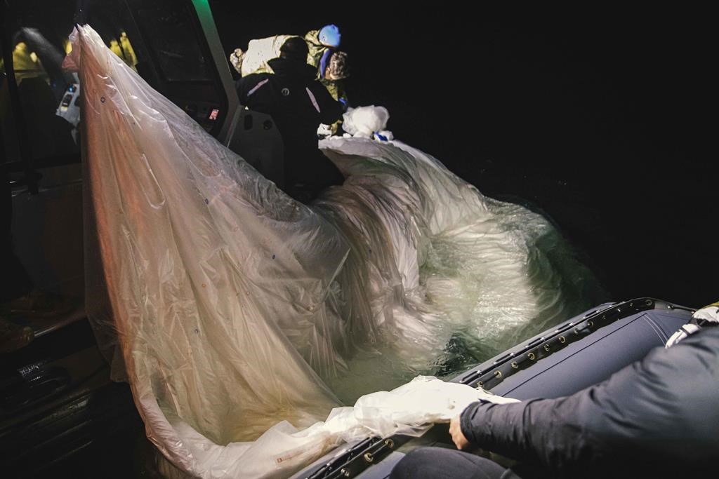 This image provided by the U.S. Navy shows sailors assigned to Explosive Ordnance Disposal Group 2 recovering a high-altitude surveillance balloon off the coast of Myrtle Beach, S.C., Feb. 5, 2023. Canada’s defence minister says the United States is still trying to determine whether China’s surveillance balloon collected any intelligence from either country when it was over North America last week. THE CANADIAN PRESS-U.S. Navy via AP  *MANDATORY CREDIT*