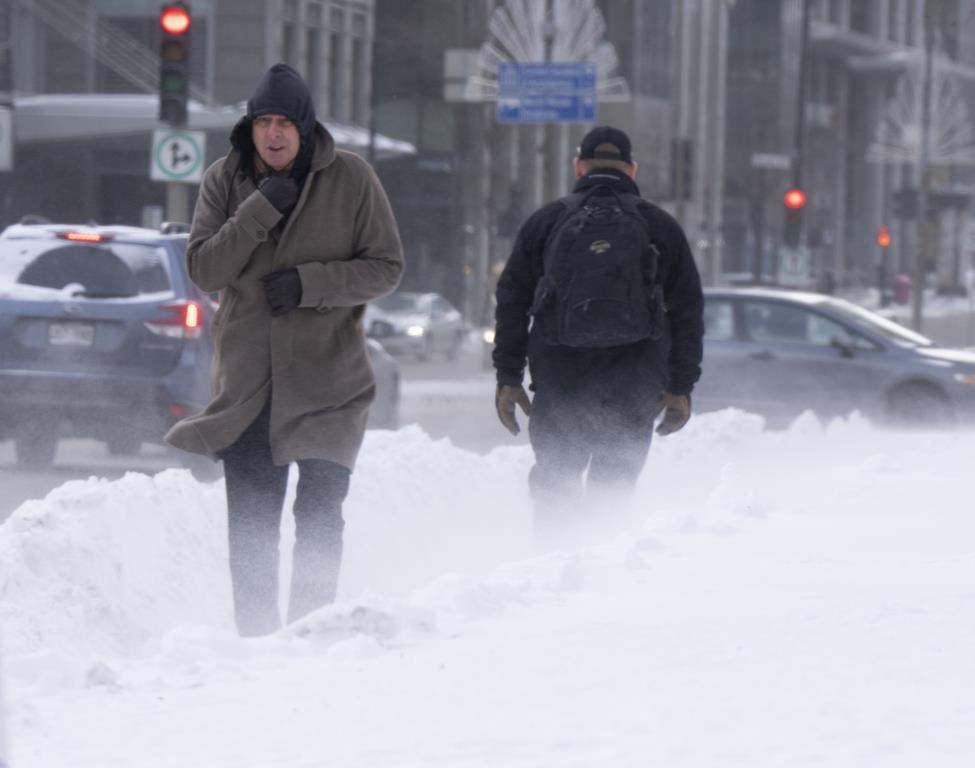 Pedestrians brave the wind and frigid temperatures as they walk downtown Friday, Feb. 3, 2023, in Montreal.THE CANADIAN PRESS/Ryan Remiorz