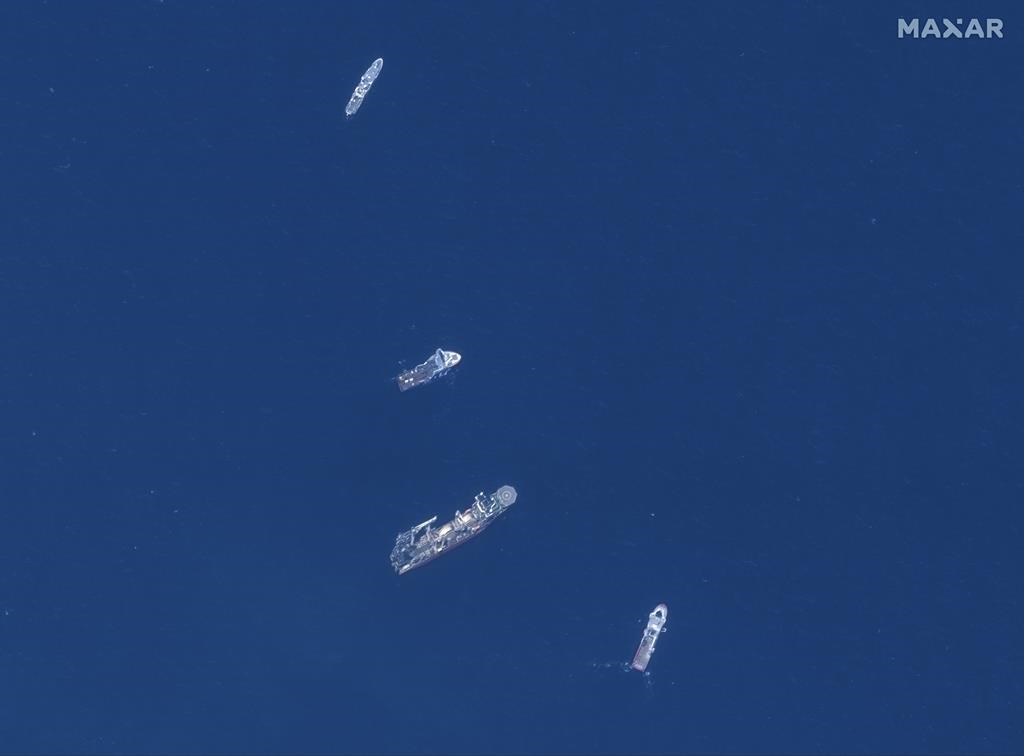 In this satellite image, from top to bottom, the vessels L'Atalante, Horizon Arctic, Deep Energy, and Skandi Vinland search for the missing submersible Titan, Thursday June 22, 2023 in the Atlantic Ocean.