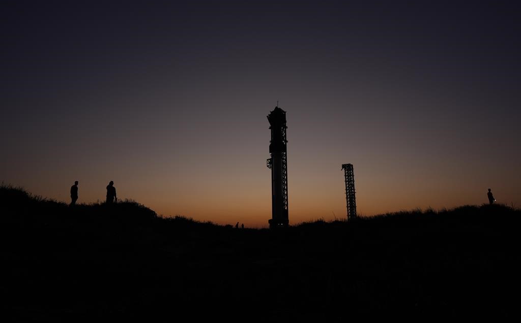 The sun sets behind SpaceX's mega rocket Starship, Saturday, Oct. 12, 2024, in Boca Chica, Texas. (AP Photo/Eric Gay)