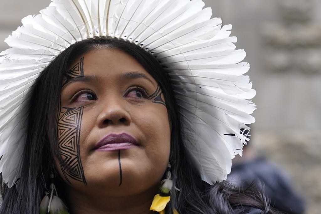 Wakrewa Krenak, from Brazil, stands outside the Royal Courts of Justice in London, Monday, Oct. 21, 2024, as lawyers representing around 620,000 Brazilians as well as businesses, municipal governments, and members of the Krenak indigenous tribe are bringing a multibillion-pound legal action against BHP Group following the collapse of the Fundao dam in November 2015. (AP Photo/Alberto Pezzali)