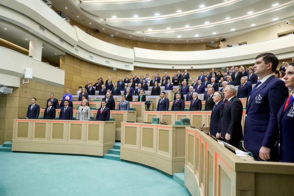 Sur cette photo publiée par le service de presse du Conseil de la Fédération de l'Assemblée fédérale de la Fédération de Russie, les législateurs du Conseil de la Fédération de l'Assemblée fédérale de la Fédération de Russie écoutent l'hymne national avant une session à Moscou, mercredi 20 novembre 2024. 