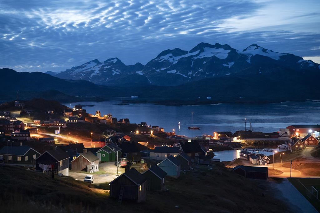 FILE - Homes are illuminated after the sunset in Tasiilaq, Greenland, Friday Aug. 16, 2019.(AP Photo/Felipe Dana, File)