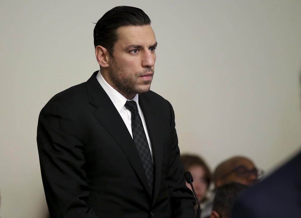 FILE - Boston Bruins forward Milan Lucic stands during his arraignment Tuesday, Nov. 21, 2023, in Boston Municipal Court, in Boston, on an assault charge in connection with his arrest over the weekend after his wife called police to their home and said he tried to choke her. Prosecutors dropped a domestic violence charge against Boston Bruins forward Milan Lucic on Friday, Feb. 16, 2024, saying the decision by his wife to invoke marital privilege made it impossible for them to prove their case beyond a reasonable doubt.(Jonathan Wiggs/The Boston Globe via AP, Pool, File)