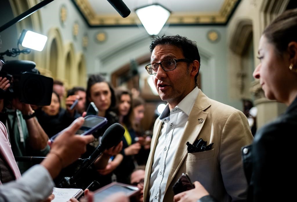 Justice Minister and Attorney General of Canada Arif Virani speaks to reporter ahead of a cabinet meeting on Parliament Hill in Ottawa, on Tuesday, June 11, 2024. THE CANADIAN PRESS/Spencer Colby