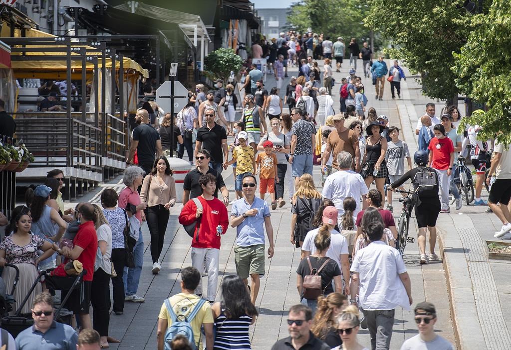 Statistics Canada says the country's population topped 41 million people in the first quarter of this year as it grew by 0.6 per cent. Pedestrians walk in Place Jacques-Cartier in Old Montreal on Sunday, July 4, 2021. THE CANADIAN PRESS/Graham Hughe