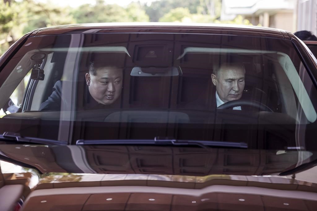 Russian President Vladimir Putin, right, and North Korea's leader Kim Jong Un drive a Russian Aurus limousine during their meeting in Pyongyang, North Korea, on Wednesday, June 19, 2024. (Gavriil Grigorov, Sputnik, Kremlin Pool Photo via AP)