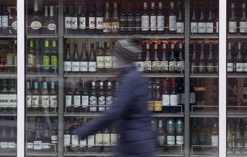 Thousands of workers are now on strike for the first time in the history of the LCBO. A person walks past shelves of bottles of alcohol on display at an LCBO in Ottawa, Thursday March 19, 2020. THE CANADIAN PRESS/Adrian Wyld