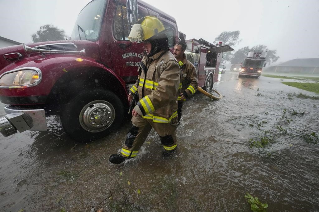 Morgan City firefighters respond to a home fire during Hurricane Francine in Morgan City, La., Wednesday, Sept. 11, 2024. (AP Photo/Gerald Herbert)